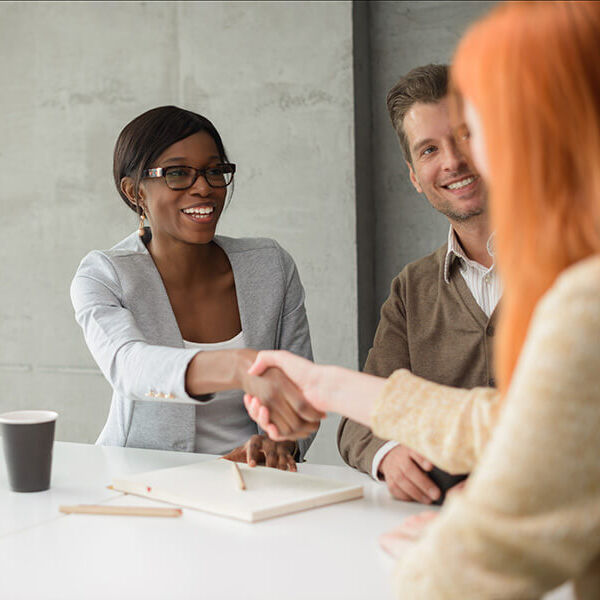 Shot of a young couple meeting with their financial advisor.